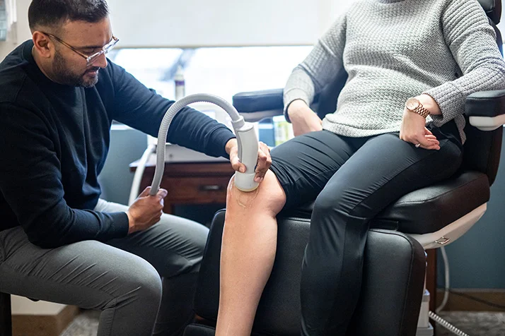 Chiropractor Blaine MN Dave Oommen Treating Patient Chiropractor Blaine MN Dave Oommen Treating Patient