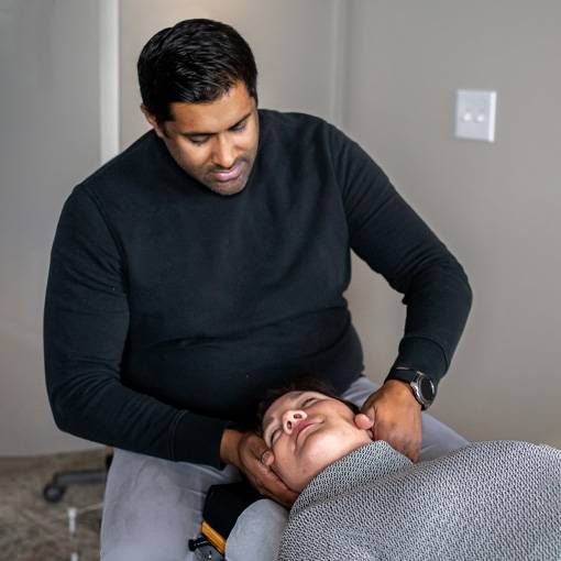 Chiropractor Blaine MN Phil Oommen With Patient